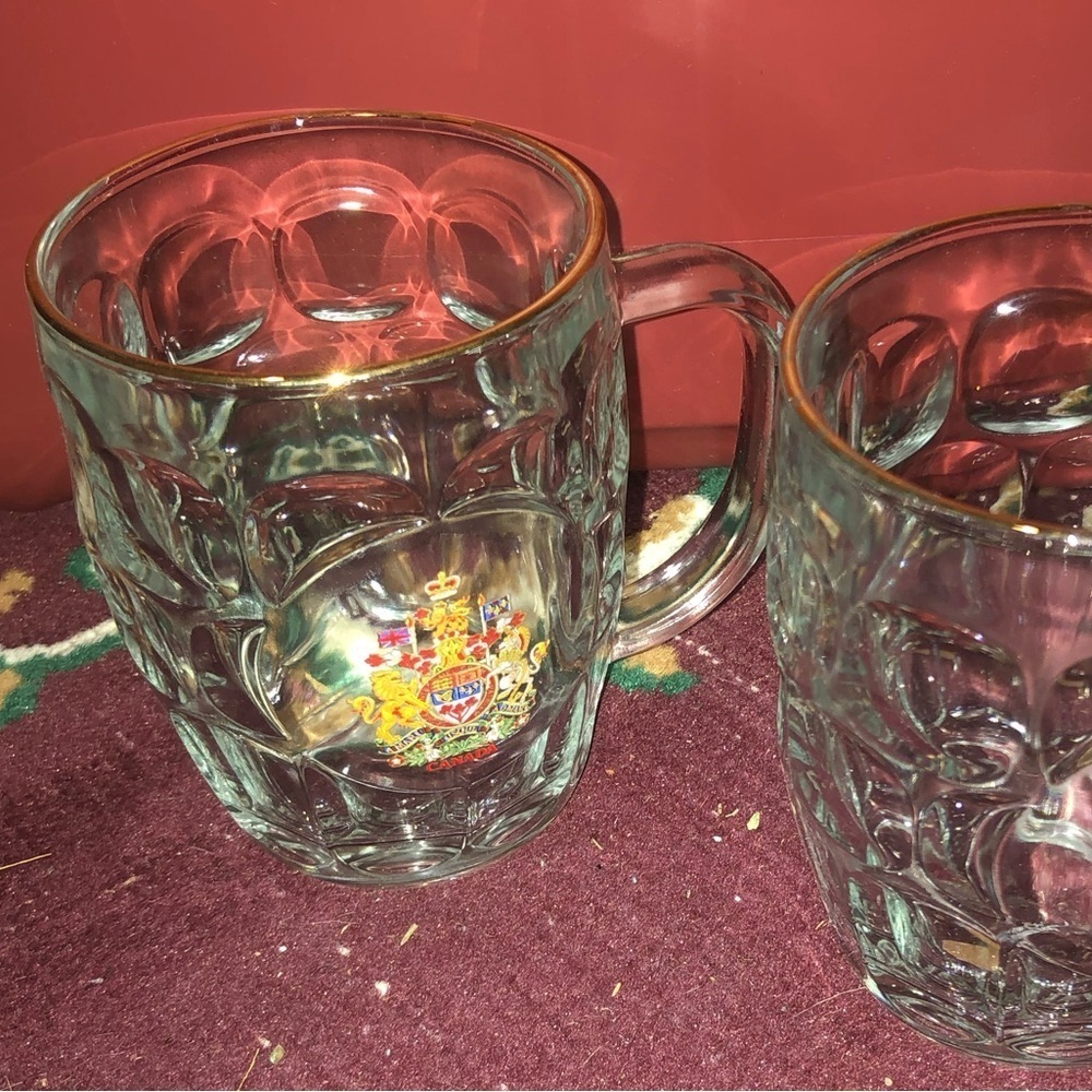 Two beer pint glasses with the Canadian emblem on them. No chips or cracks.